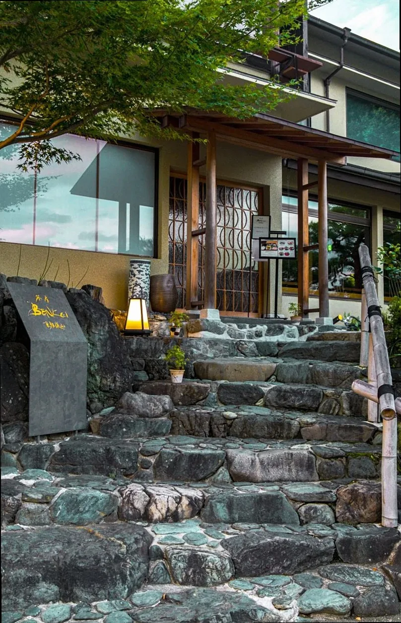 Charming view of a traditional house with stone steps in Kyoto, Japan, showcasing Japanese architecture.